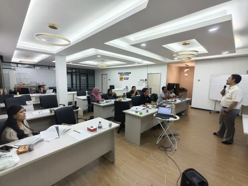 Participants seated at desks in a training room during an ergonomics seminar
