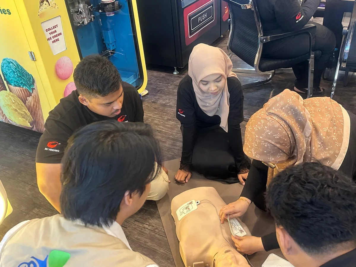 Participant practising CPR on a manikin during a first aid class